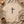 Beige t-shirt with a black cross and 'FAITH' text on a textured surface with a candle and cup.